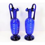 A pair of Victorian Bristol blue glass ewers with