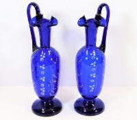 A pair of Victorian Bristol blue glass ewers with