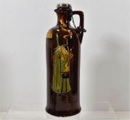 A Doulton Noke whisky bottle with silver stopper &