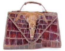An early 20thC. crocodile skin ladies handbag