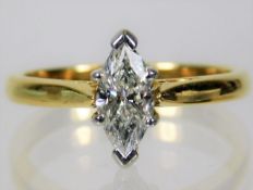 A 18ct gold ring set with marquise cut diamond sol