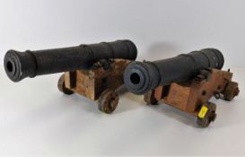 A pair of large oak mounted desk cannons
