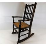 A small childs rush seat rocking chair