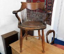 A c.1900 leather seated oak stick back desk chair