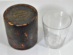 A Victorian boxed medicine glass