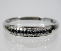 A 9ct white gold ring set with black & white diamo