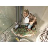 A Capodimonte figure group of man & dog
