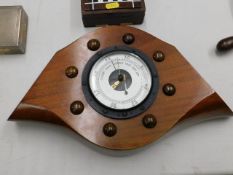 A barometer set within a mahogany propeller centre