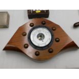 A barometer set within a mahogany propeller centre