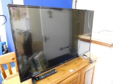 A Bush flat screen television with remote control