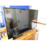 A Bush flat screen television with remote control