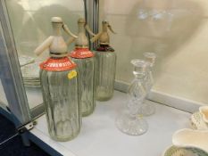 Three vintage soda syphons twinned with a pair of