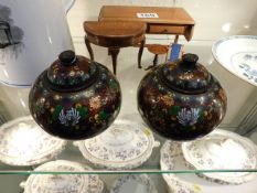 A pair of Oriental cloisonne pots with covers