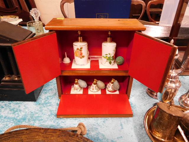 A Limoges cased shop display perfume cabinet with