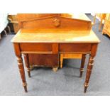 A oak hall table with shield decor on rear plinth