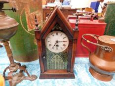 A mahogany mantle clock with cathedral style decor