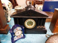 A slate clock twinned with a German porcelain Merc
