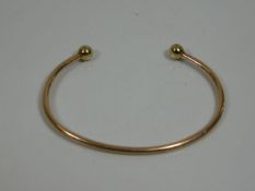 A 9ct gold bangle 8.5g