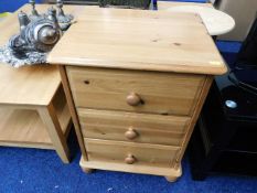 A modern pine three drawer bedside chest