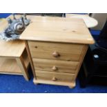 A modern pine three drawer bedside chest