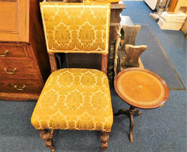 An antique upholstered oak chair twinned with mode