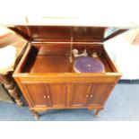 A vintage gramophone in mahogany cabinet