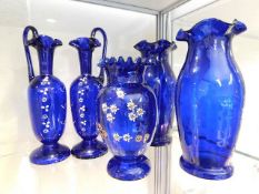 A pair of Victorian Bristol blue glass ewers with