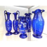 A pair of Victorian Bristol blue glass ewers with