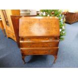 An elegant ladies bureau with burr walnut veneer