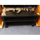 A glass topped modern TV stand