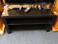 A glass topped modern TV stand