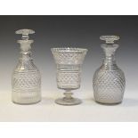 Two early 19th Century baluster shaped decanters and stoppers, each having diamond cut decoration,