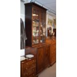 19th Century mahogany two section bookcase, the upper section fitted four shelves enclosed by a pair