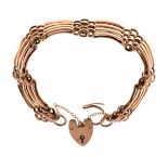 Rose gold coloured metal gate bracelet, stamped 9ct, 15.7g approx Condition: