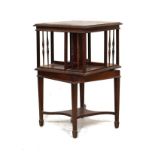 Edwardian inlaid and crossbanded mahogany square revolving bookcase standing on tapered spade