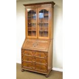 1920's period oak bureau bookcase, the upper section fitted four shelves enclosed by a pair of