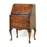 Reproduction Queen Anne style figured walnut bureau fitted fall flap enclosing a fitted interior,