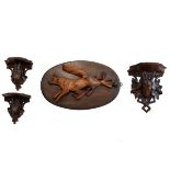 Three Black Forest carved wooden wall brackets, each decorated with the head of a mountain goat,