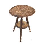 Indian carved hardwood circular topped two tier occasional table on triple spayed supports