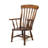 Early 20th Century beech and elm lath back Windsor style elbow chair having a hard seat and standing