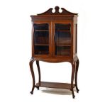 Early 20th Century mahogany display cabinet having a carved swan neck pediment, moulded cornice with