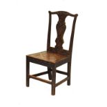 Late 19th/early 20th Century heavily carved oak hall chair having a hard seat and standing on square