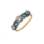 Unmarked yellow metal ring set three diamonds and two green stones, size Q, 3.1g approx gross