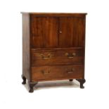 Mahogany and beech two door cupboard fitted two drawers and standing on cabriole supports Condition: