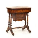 Victorian string inlaid and crossbanded figured walnut games/work table, the fold over top opening