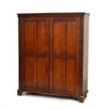 19th Century mahogany and beech two door cupboard, the panelled doors opening to reveal an