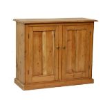 Early 20th Century stripped pine two door cupboard standing on a plinth base Condition: