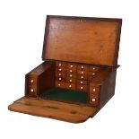 Early 20th Century stained pine watch repairers slope front travelling case, the hinged cover