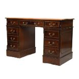 Reproduction mahogany finish double pedestal kneehole desk having an inset leather top, fitted eight