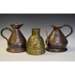 Two 19th Century haystack measures, together with a Middle Eastern embossed brass ewer having